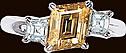 Platinum ring with one Rhomboid Yellow Diamond and two Square Emerald Cut Diamondsonds